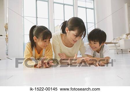 Stock Photography - Family Laying Down on Floor. Fotosearch