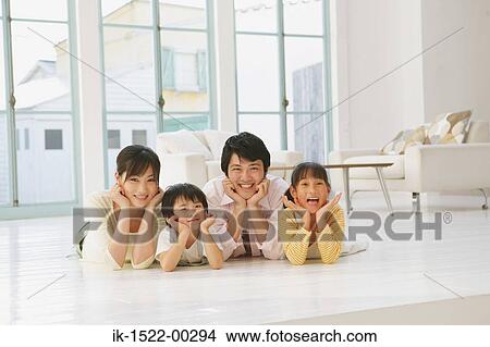Family Laying Down, Smiling View Large Photo Image Picture - Family Laying Down, Smiling. Fotosearch