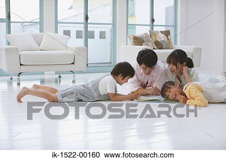 Stock Image - Family Reading a Book Together. Fotosearch