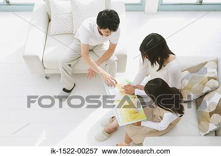 Stock Photo - Family Reading a Book Together. Fotosearch