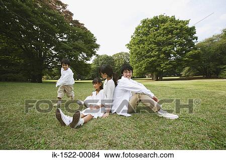 Family Sitting Down in Park View Large Photo Image Picture - Family Sitting Down in Park. Fotosearch