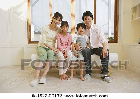 Stock Image - Family Sitting Down on Couch. Fotosearch