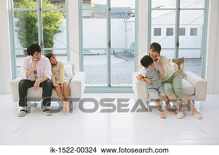 Family Sitting In Separate Chairs Picture