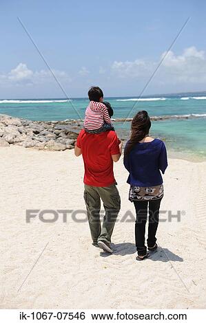 Family walking on beach View Large Photo Image Stock Photograph - Family walking on beach. Fotosearch