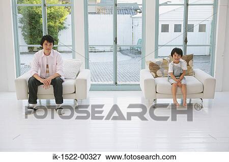 Father and Son Sitting Down in Comfy Chairs View Large Photo Image Stock Photo - Father and Son Sitting Down in Comfy Chairs. Fotosearch