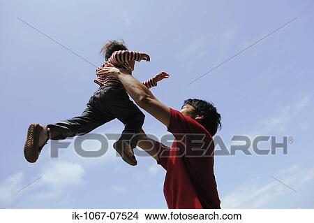 Father lifting child into air View Large Photo Image Picture - Father lifting child into air. Fotosearch