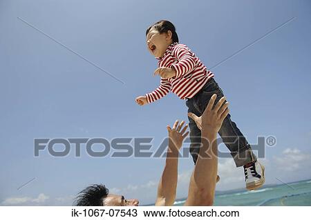 Father lifting child into air View Large Photo Image Stock Image - Father lifting child into air. Fotosearch