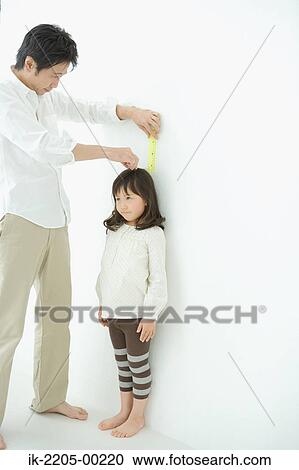 Father measuring daughter height on wall View Large Photo Image Stock Image - Father measuring daughter height on wall. Fotosearch