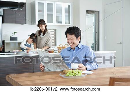 Father reading newspaper with family in background View Large Photo Image Stock Image - Father reading newspaper with family in background. Fotosearch