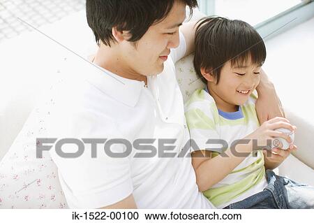 Stock Image - Father Sitting with Son. Fotosearch