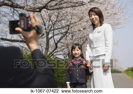 Father taking a family photograph on road View Large Photo Image Stock Image - Father taking a family photograph on road. Fotosearch