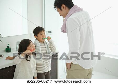 Father with his children brushing teeth View Large Photo Image Stock Photo - Father with his children brushing teeth. Fotosearch