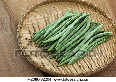 Picture - French beans in straw tray. Fotosearch