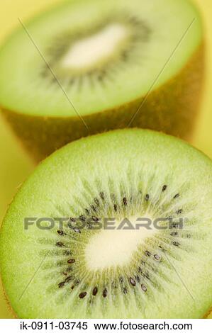Stock Photography - Fresh kiwi fruit cut halved into pieces. Fotosearch