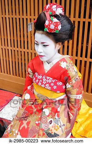 Stock Image - Geisha in Traditional Make-Up and Wearing Kimono. Fotosearch