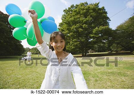 Picture - Girl Holding Balloons. Fotosearch