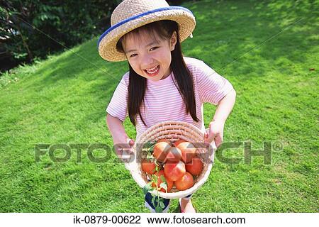 Girl holding basket of tomatoes View Large Photo Image Stock Image - Girl holding basket of tomatoes. Fotosearch