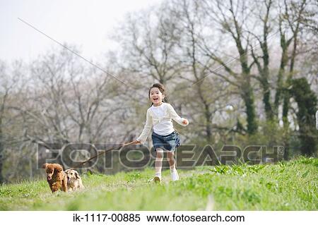 Stock Photography - Girl running with her dogs. Fotosearch