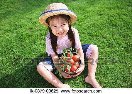 Girl sitting on grass with bucket of tomatoes View Large Photo Image Stock Photography - Girl sitting on grass with bucket of tomatoes. Fotosearch