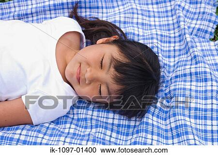 Girl sleeping on a blanket View Large Photo Image Stock Image - Girl sleeping on a blanket. Fotosearch