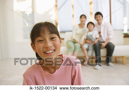 Girl with Family in Background View Large Photo Image Picture - Girl with Family in Background. Fotosearch