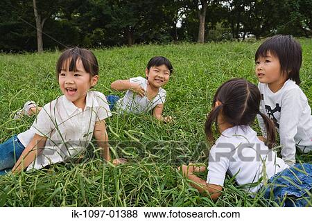 Girls playing on grass in a park View Large Photo Image Stock Photo - Girls playing on grass in a park. Fotosearch