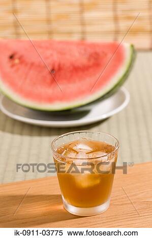 Stock Photography - Glass of whisky with watermelon. Fotosearch