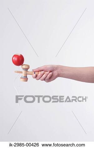 Stock Photograph - Hands Holding Kendama. Fotosearch