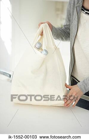 Hands of a person holding bag View Large Photo Image Stock Image - Hands of a person holding bag. Fotosearch