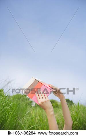 Hands of a person holding book View Large Photo Image Picture - Hands of a person holding book. Fotosearch