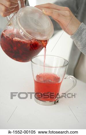 Hands of a person pouring herbal tea View Large Photo Image Stock Photography - Hands of a person pouring herbal tea. Fotosearch