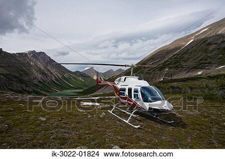 Helicopter Landing Near Mountain in Alberta View Large Photo Image Picture - Helicopter Landing Near Mountain in Alberta. Fotosearch