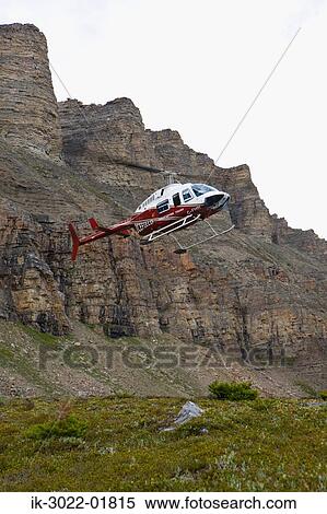 Stock Photography - Helicopter Landing Near Mountain in Alberta. Fotosearch