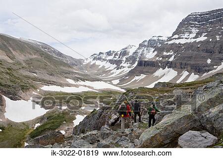 Hikers Walking in Mountain Range, Canada View Large Photo Image Stock Photo - Hikers Walking in Mountain Range, Canada. Fotosearch