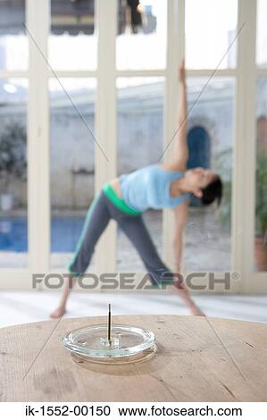 Incense stick placed in front of exercising woman View Large Photo Image Stock Image - Incense stick placed in front of exercising woman. Fotosearch