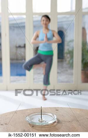 Incense stick placed in front of exercising woman View Large Photo Image Stock Image - Incense stick placed in front of exercising woman. Fotosearch