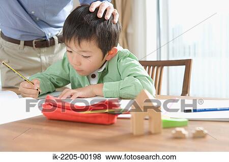 Stock Photo - Japanese boy doing his homework. Fotosearch