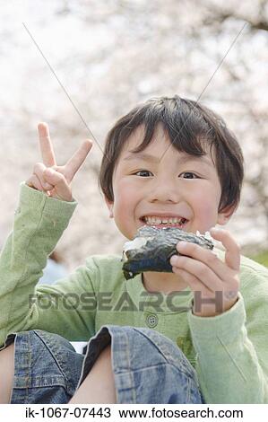 Japanese boy eating sushi and showing v sign View Large Photo Image Stock Image - Japanese boy eating sushi and showing v sign. Fotosearch