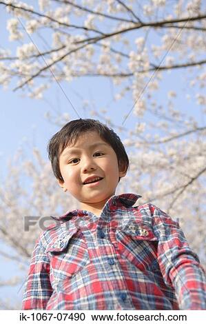 Stock Image - Japanese boy looking at camera. Fotosearch