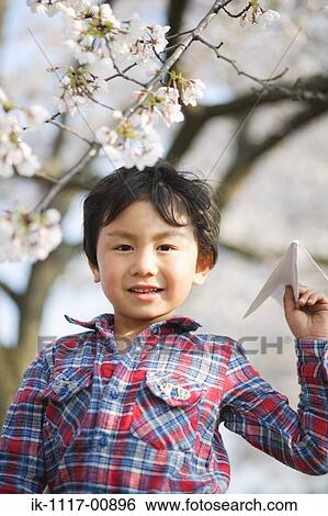 Japanese boy playing with paper plane View Large Photo Image Stock Photograph - Japanese boy playing with paper plane. Fotosearch