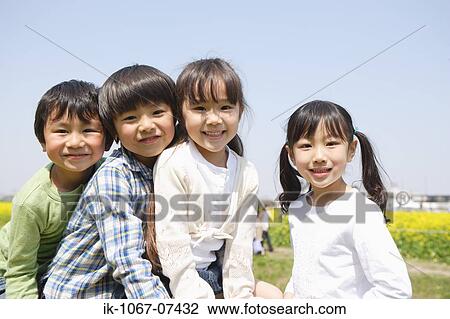 Stock Image - Japanese children smiling and looking at camera. Fotosearch