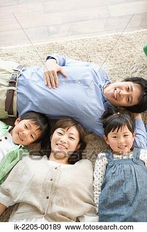 Japanese family lying down on carpet View Large Photo Image Stock Photo - Japanese family lying down on carpet. Fotosearch
