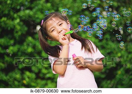 Japanese girl blowing soap bubbles View Large Photo Image Stock Image - Japanese girl blowing soap bubbles. Fotosearch