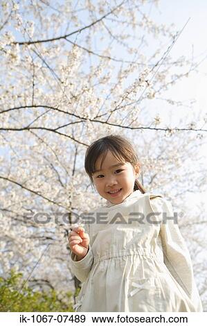 Stock Photo - Japanese girl holding flower. Fotosearch