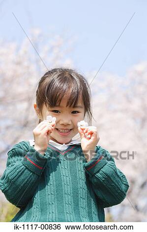 Japanese girl holding flowers and smiling View Large Photo Image Stock Photograph - Japanese girl holding flowers and smiling. Fotosearch