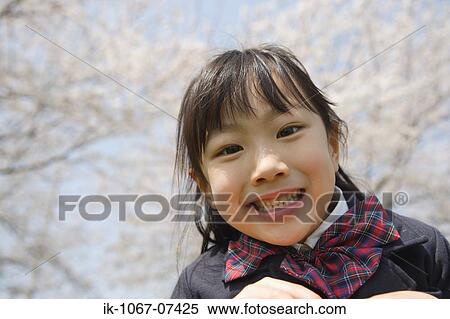 Japanese girl smiling and looking at camera View Large Photo Image Stock Photography - Japanese girl smiling and looking at camera. Fotosearch