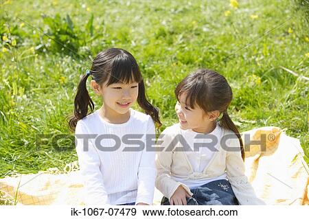 Japanese girls sitting in a garden View Large Photo Image Stock Photo - Japanese girls sitting in a garden. Fotosearch