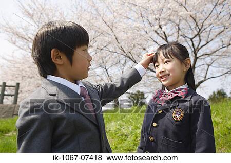 Japanese kids playing with cherry flowers View Large Photo Image Stock Photo - Japanese kids playing with cherry flowers. Fotosearch