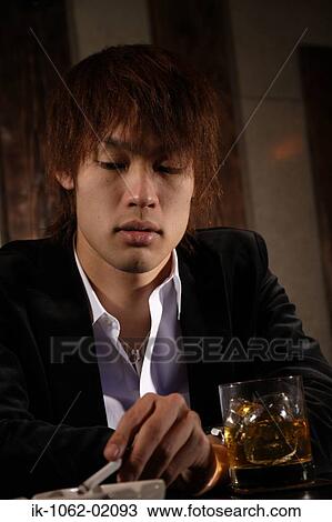 Japanese man dropping ash in an ashtray View Large Photo Image Stock Image - Japanese man dropping ash in an ashtray. Fotosearch