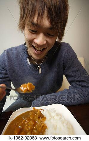 Japanese man enjoying curry and rice View Large Photo Image Stock Photo - Japanese man enjoying curry and rice. Fotosearch